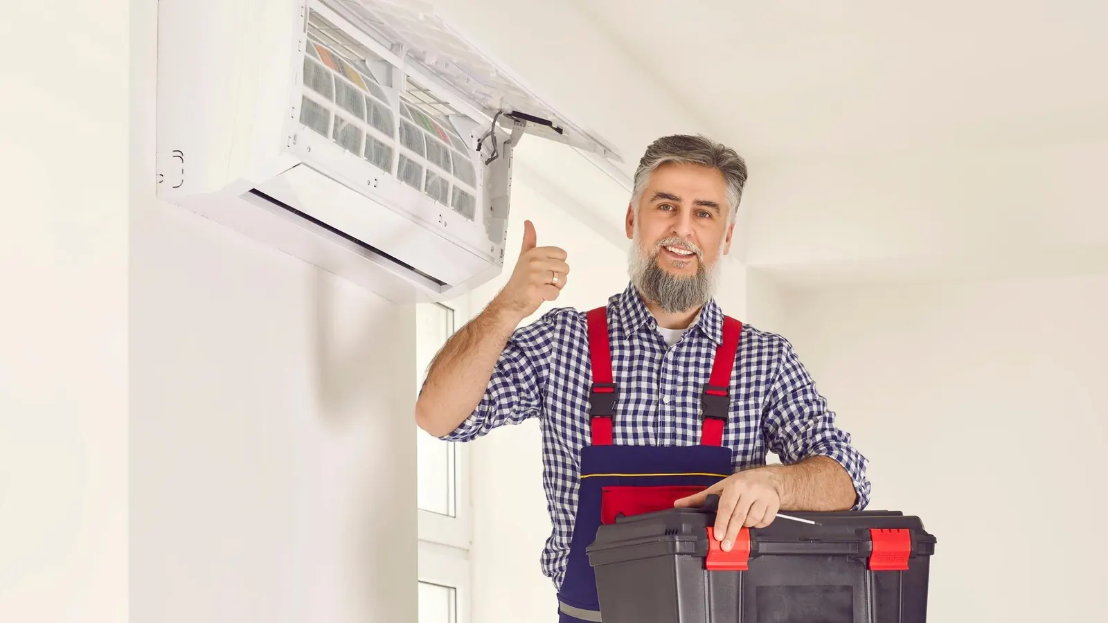 Technicien CVC souriant après l’entretien du climatiseur
